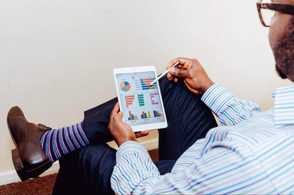 A business man looking at tracking expenses on an iPad.
