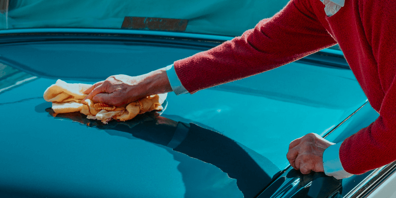 Takl: a man washing a car