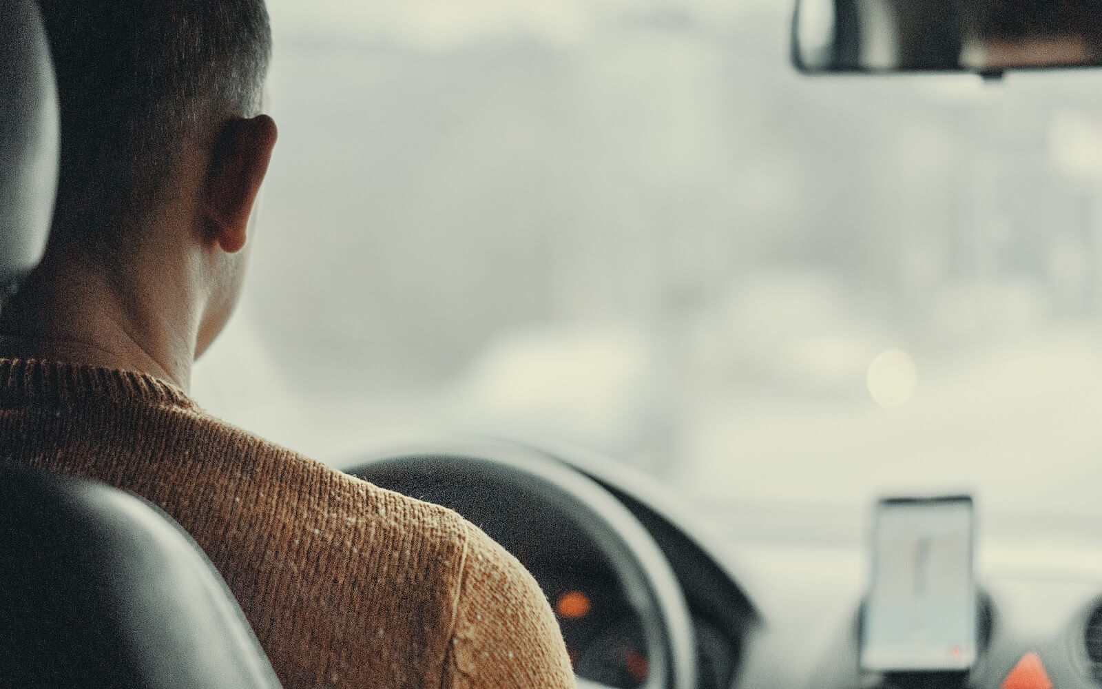 Man driving a rideshare passenger for his side jobs