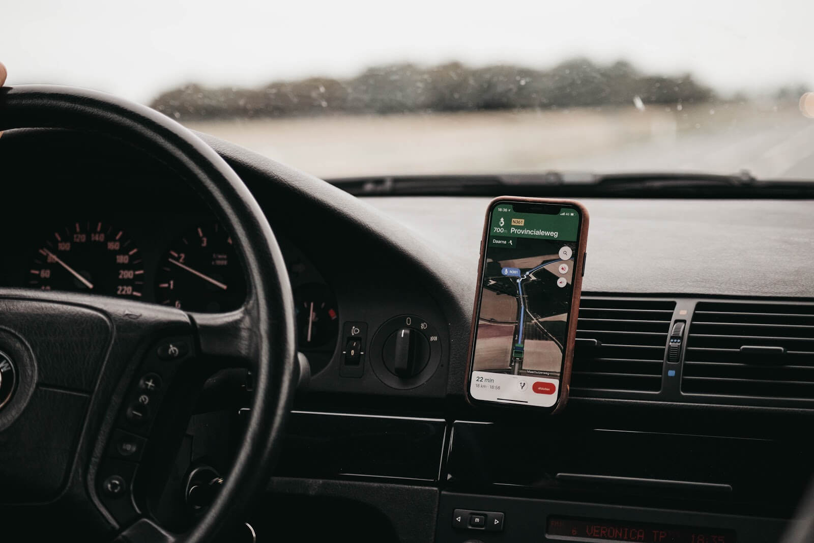 Uber for Business: a phone with GPS mounted on a car dashboard