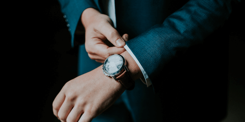 Man adjusting his suit sleeve