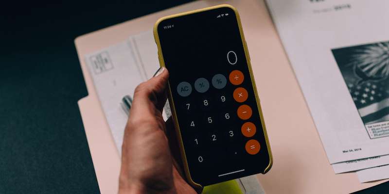 Hand holding iPhone calculator