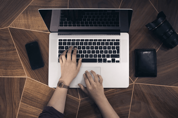 Person typing on laptop