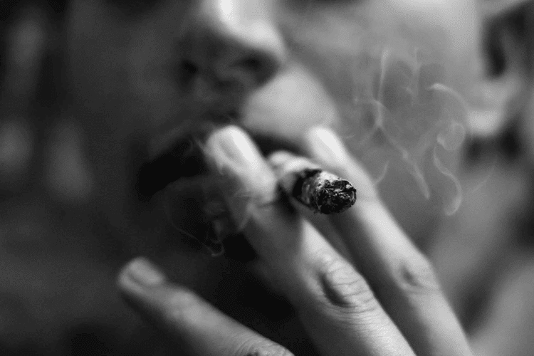 Ultimate Guide to Eaze: Person smoking a joint