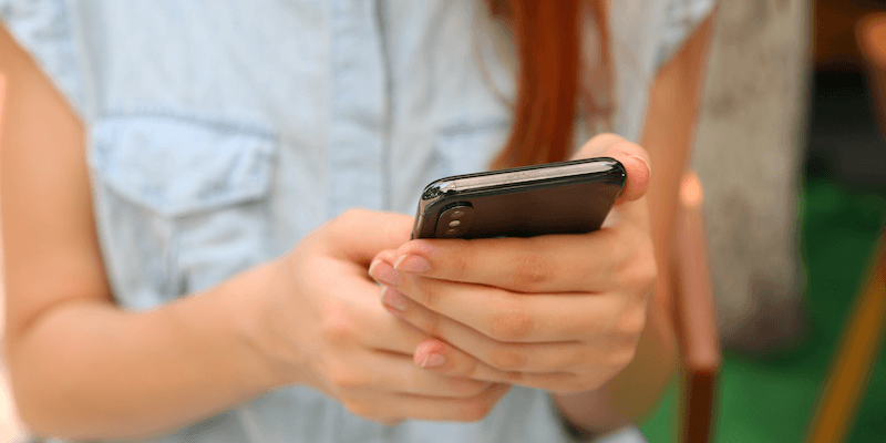 Make money online fast: A woman uses her smartphone