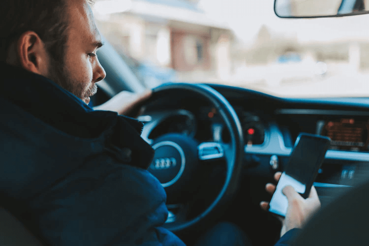 Man looking at mileage calculator