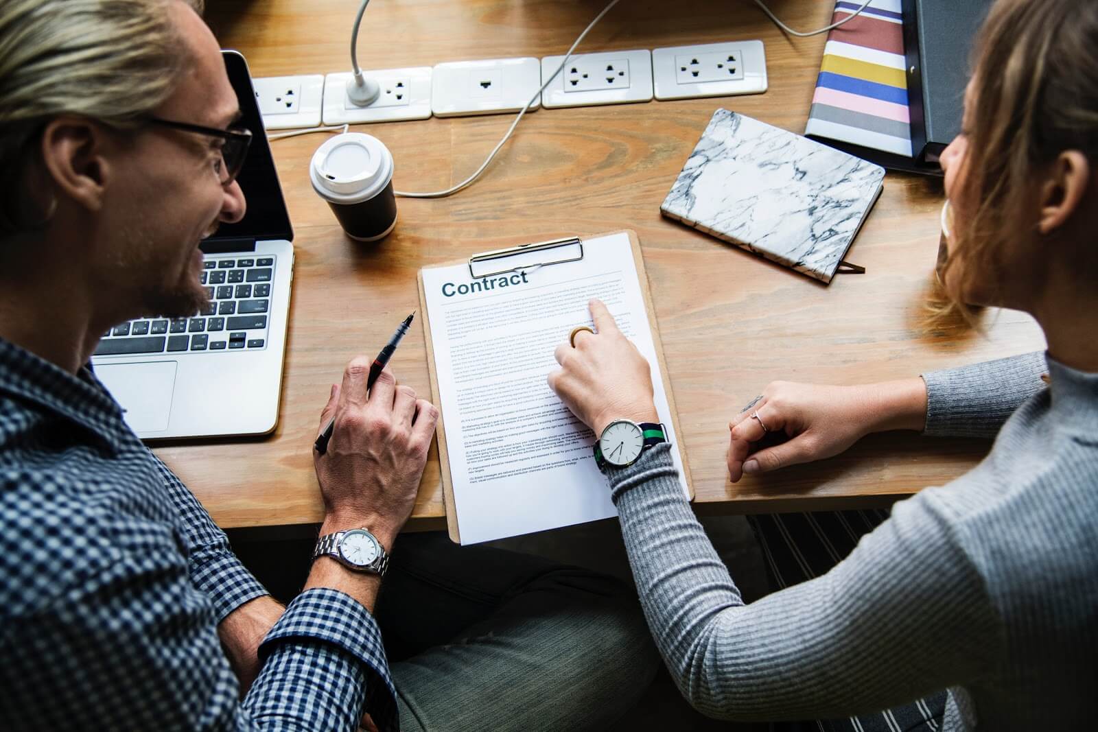 Non-compete agreement: Two people review a contract