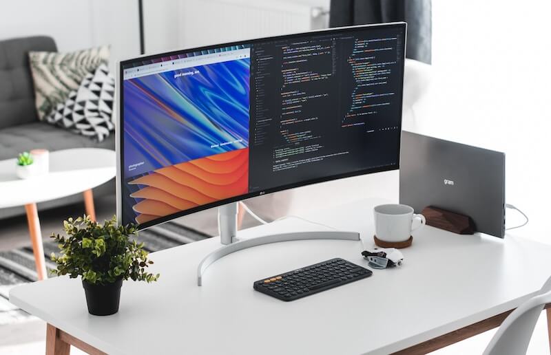 Remote IT jobs: a home office desk with code on the screen