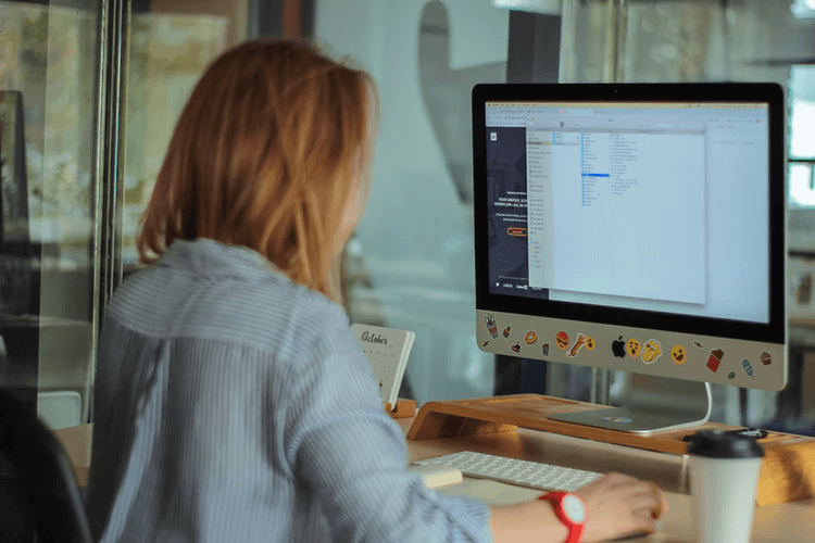 Woman works on Mac PC