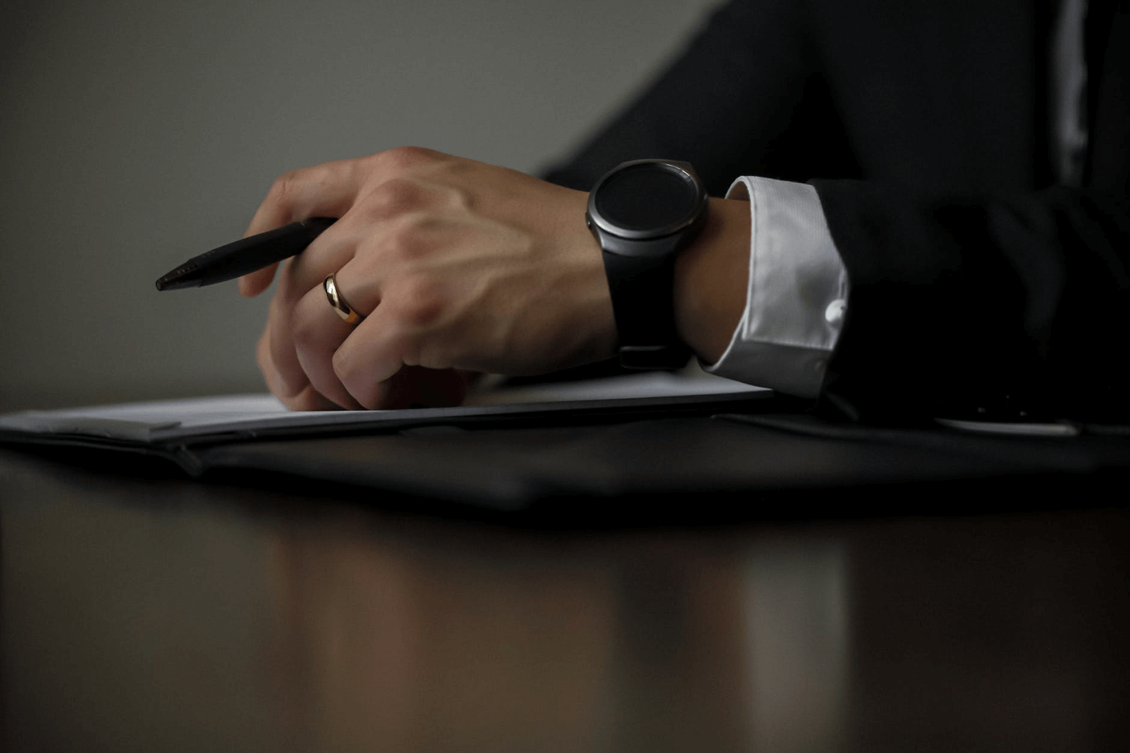 Class action rebates: A business man holds a pen
