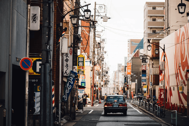 Drive for Lyft: a car driving away on a city street
