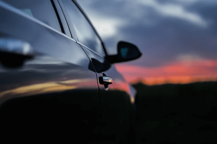 Dark car silhouette at sunset