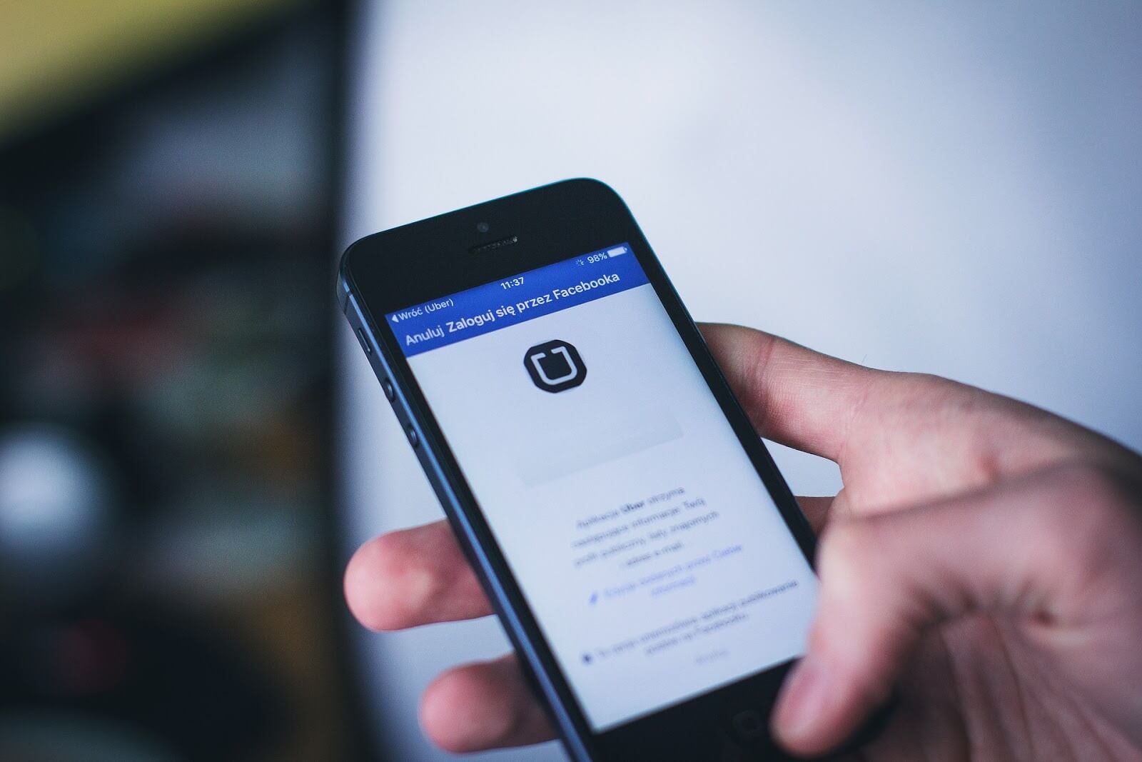 Uber receipts: A hand holds a smart phone open to an app home screen