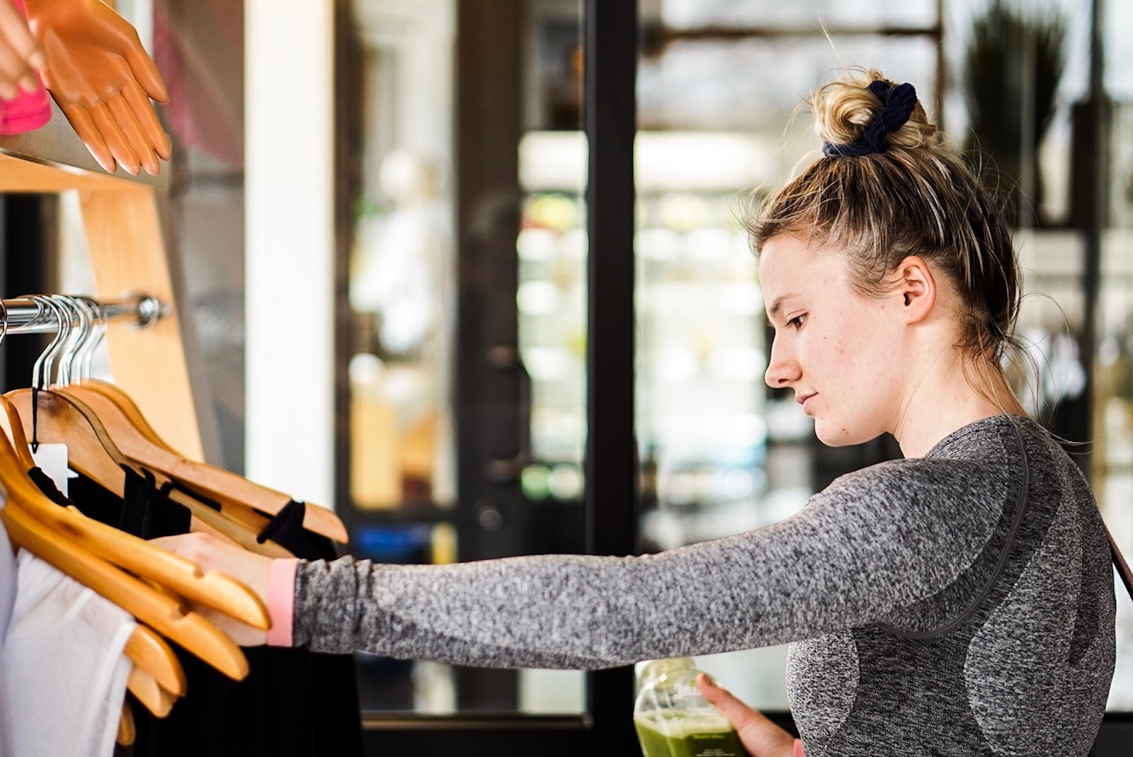 Secret shopper jobs: A woman looks at a rack of clothes