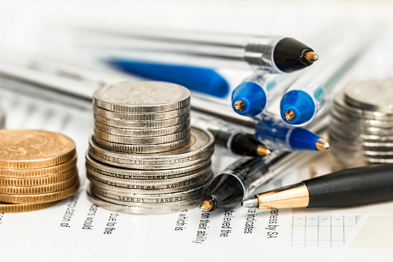 Loan amortization: stacks of coins and pens