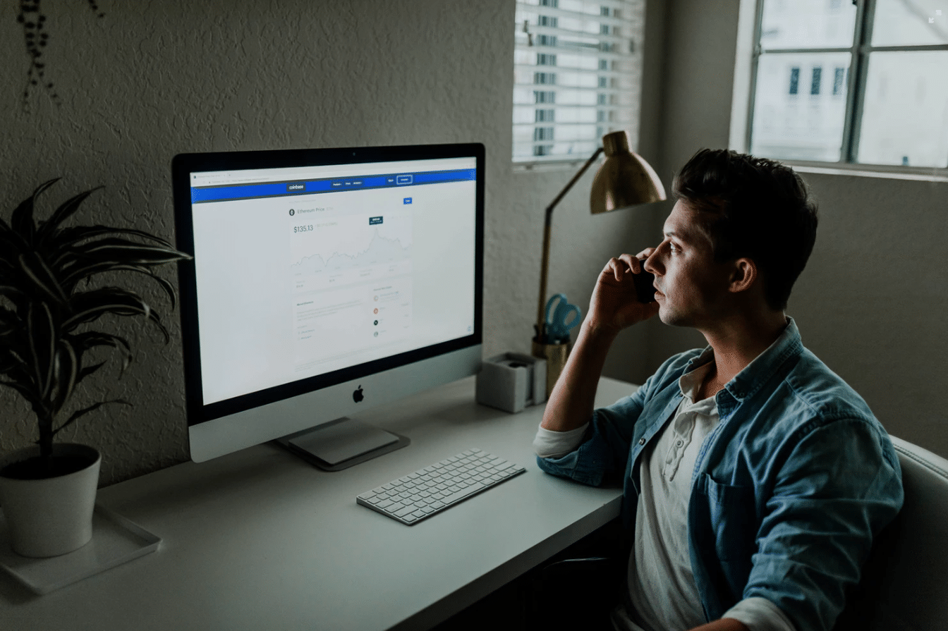 What is cash flow: A man on the phone looks at a computer screen