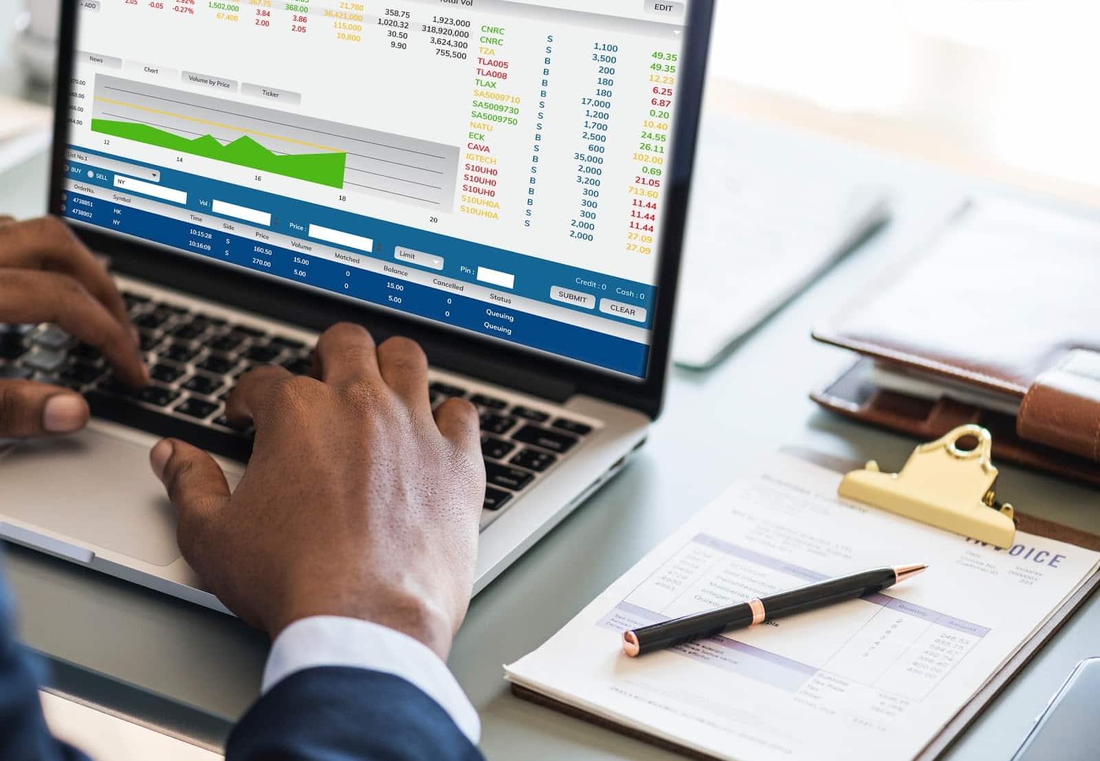 What is accrual accounting: Hands type on laptop with charts and figures on the screen