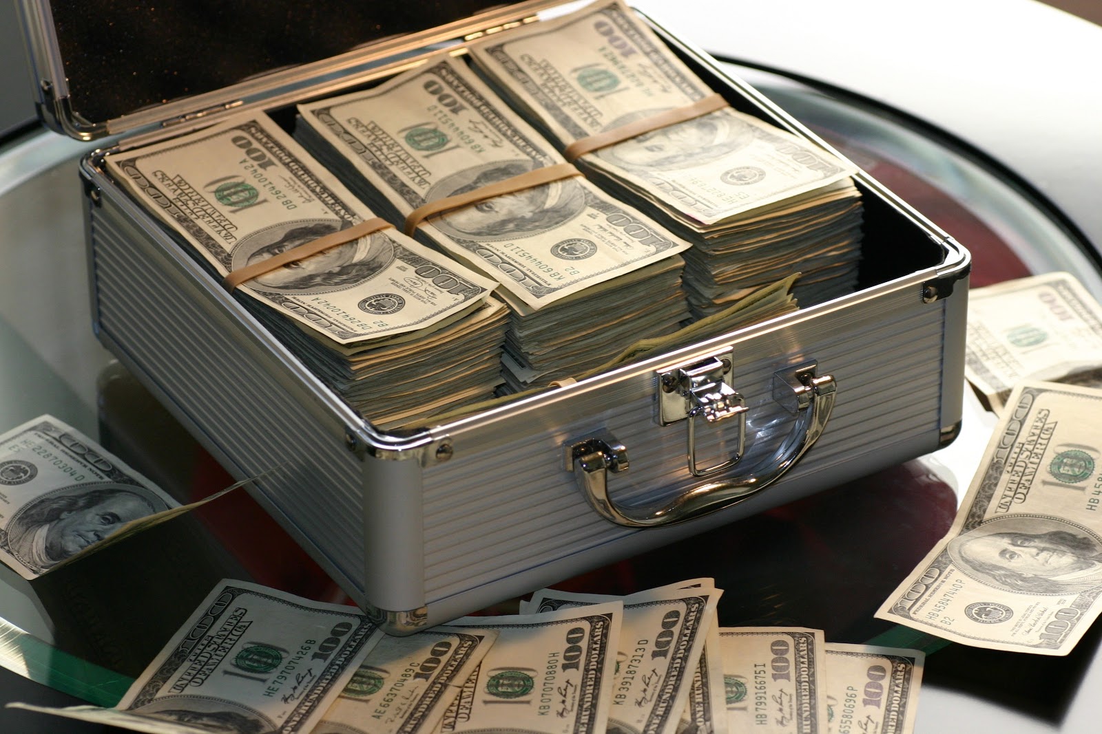 Metal briefcase loaded with hundred dollar bills