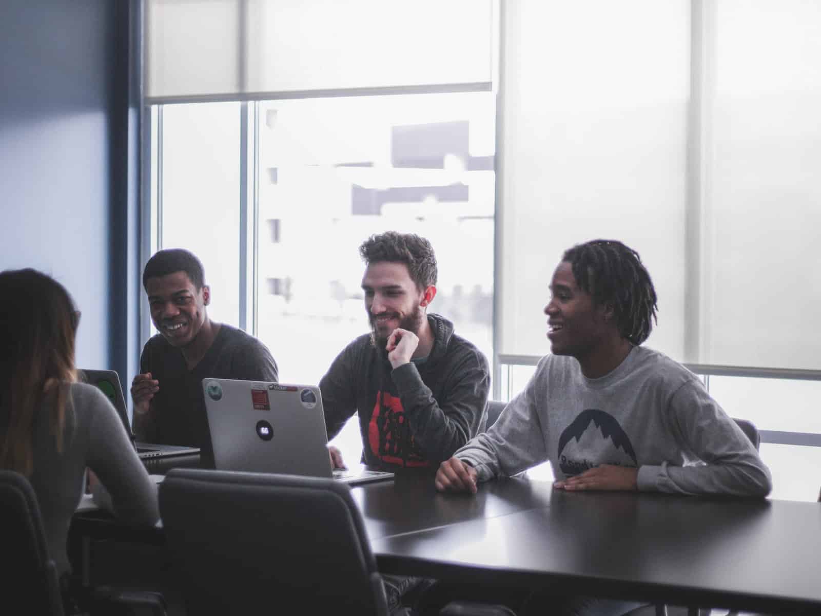Toptal: A team works around a laptop