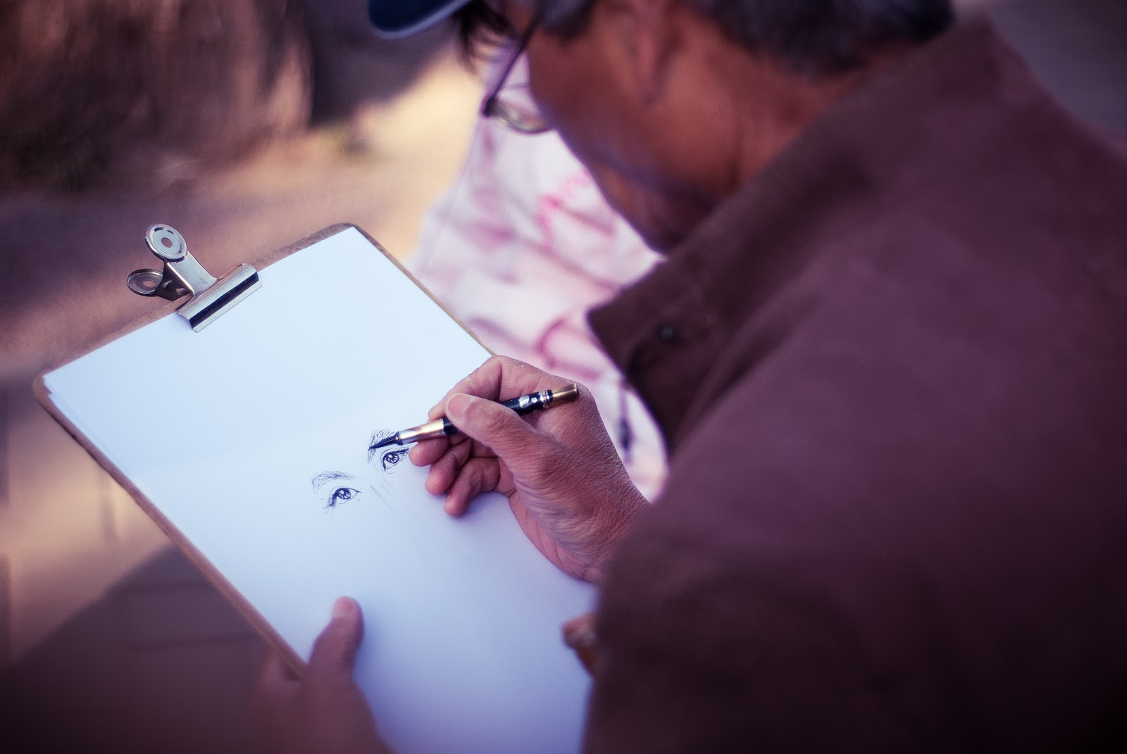 Male artist sketching human eyes