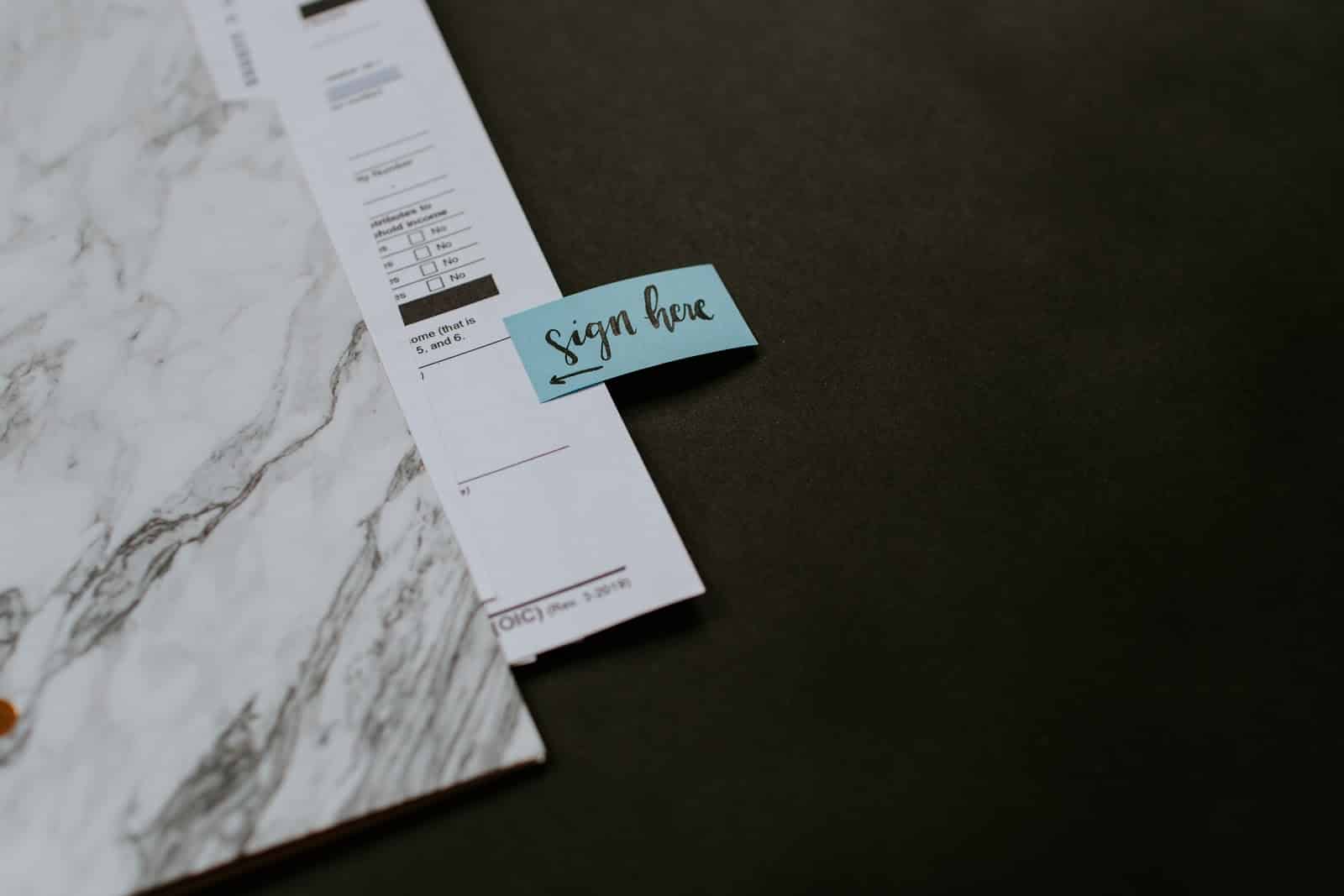 What is qualified business income: a file folder with paperwork and "sign here" sticker