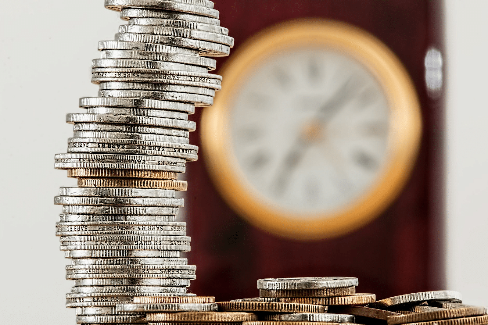 How to calculate gross profit margin: stacks of coins and a clock