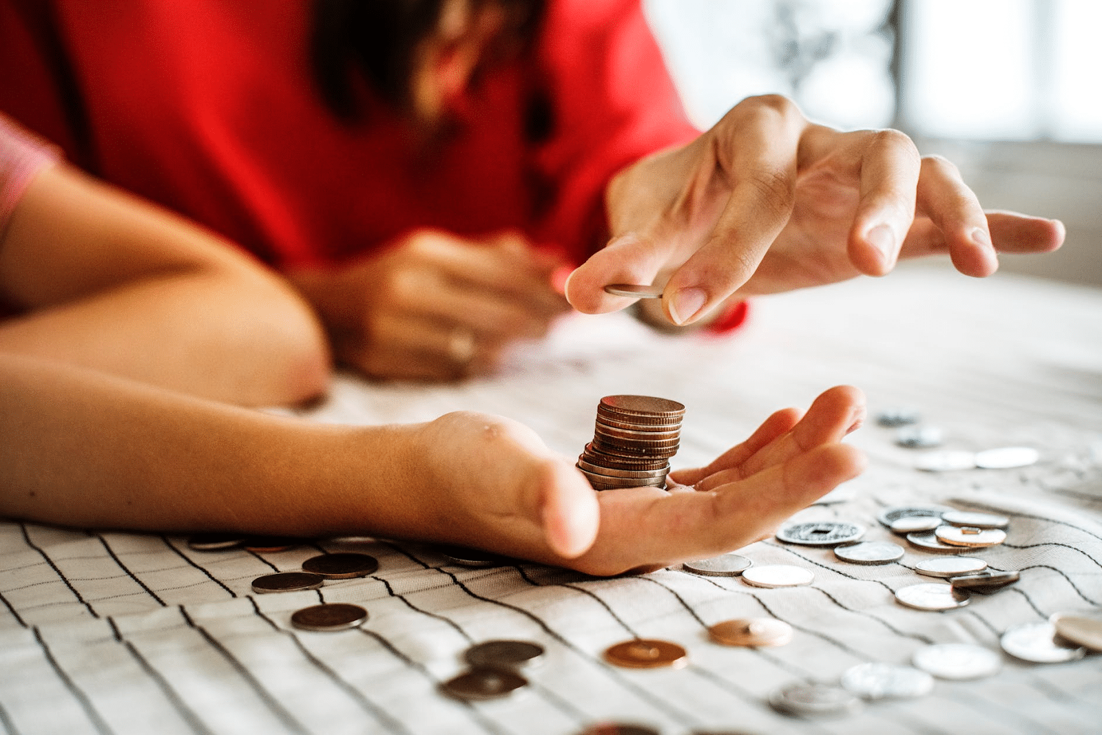 Acorns app: two people count coins