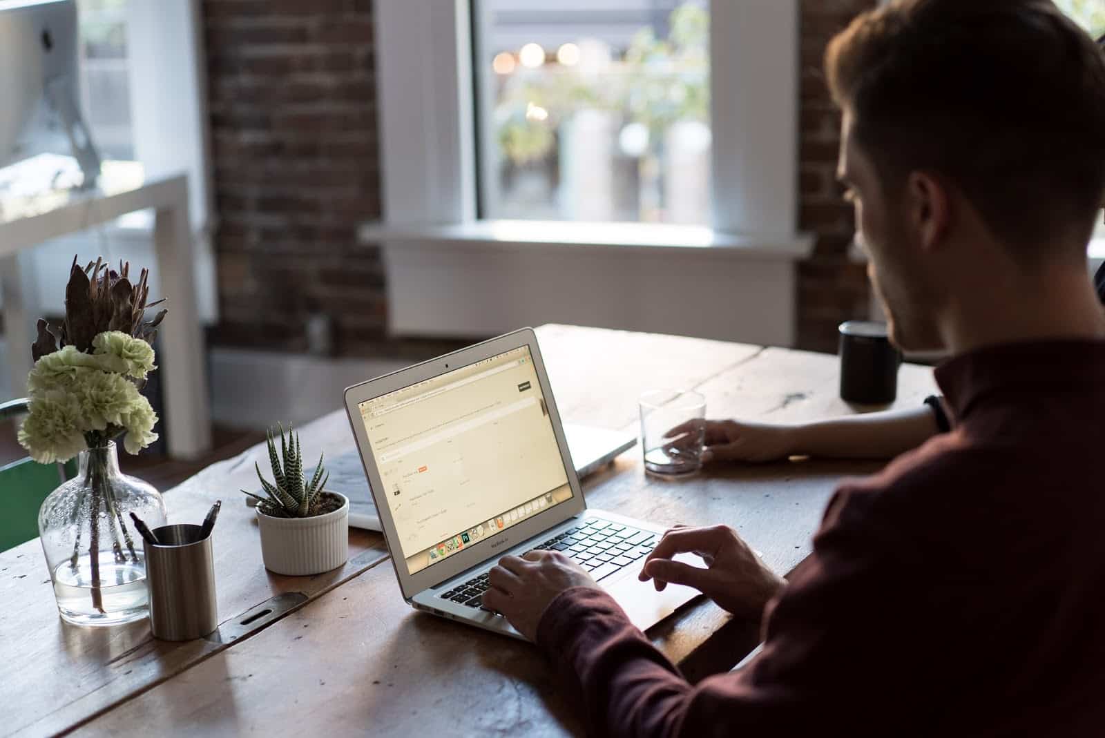 man working from laptop at a desk