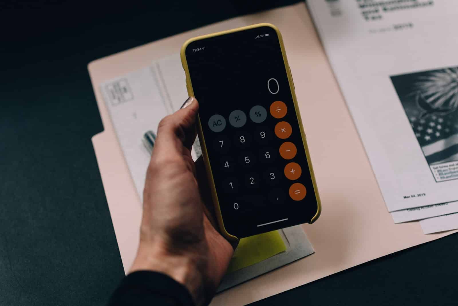 How to Calculate Depreciation: calculator app on a phone being held