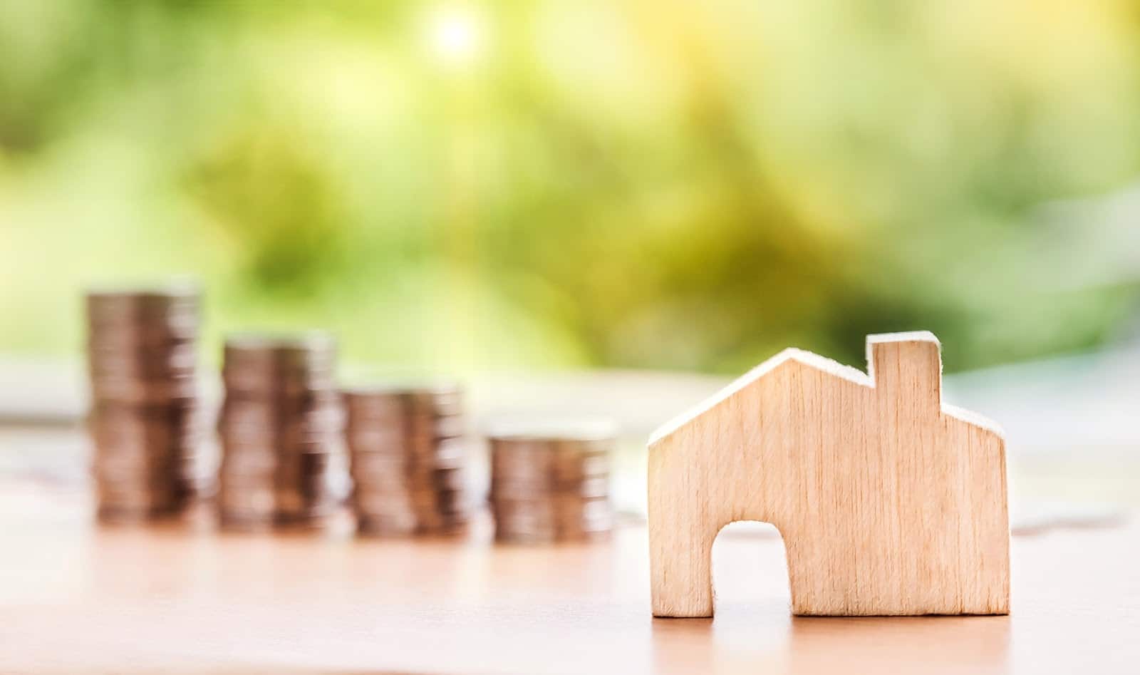 What is a secured loan? House model with stack of coins