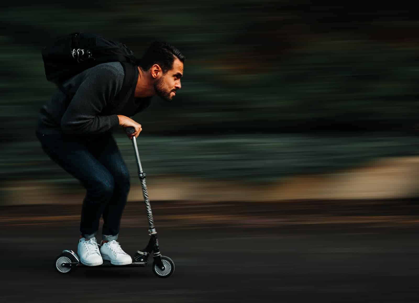 man riding a scooter