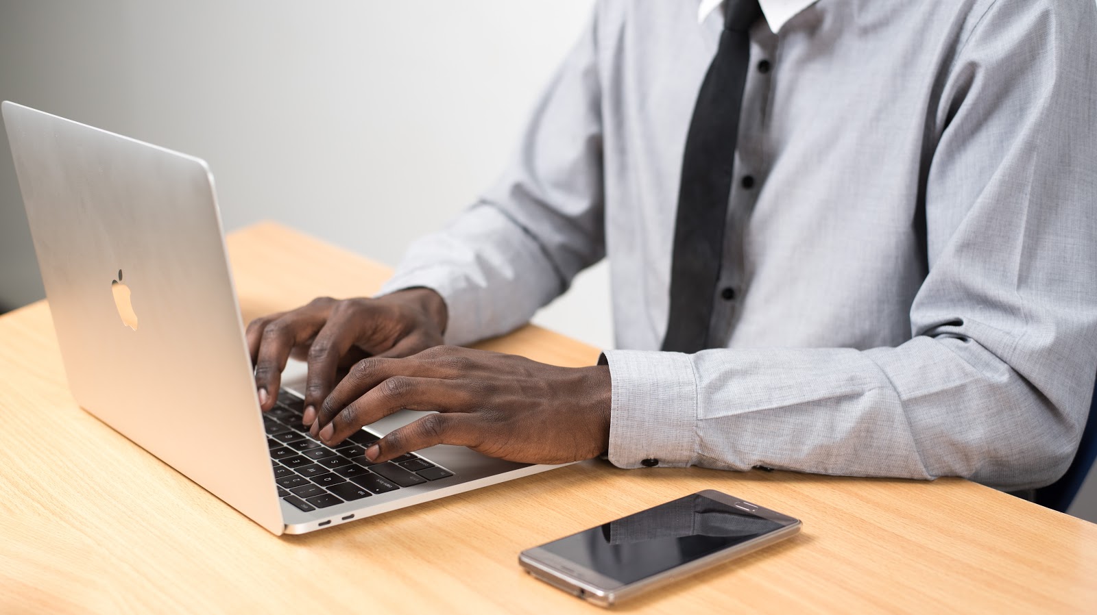business entity: person typing on laptop computer
