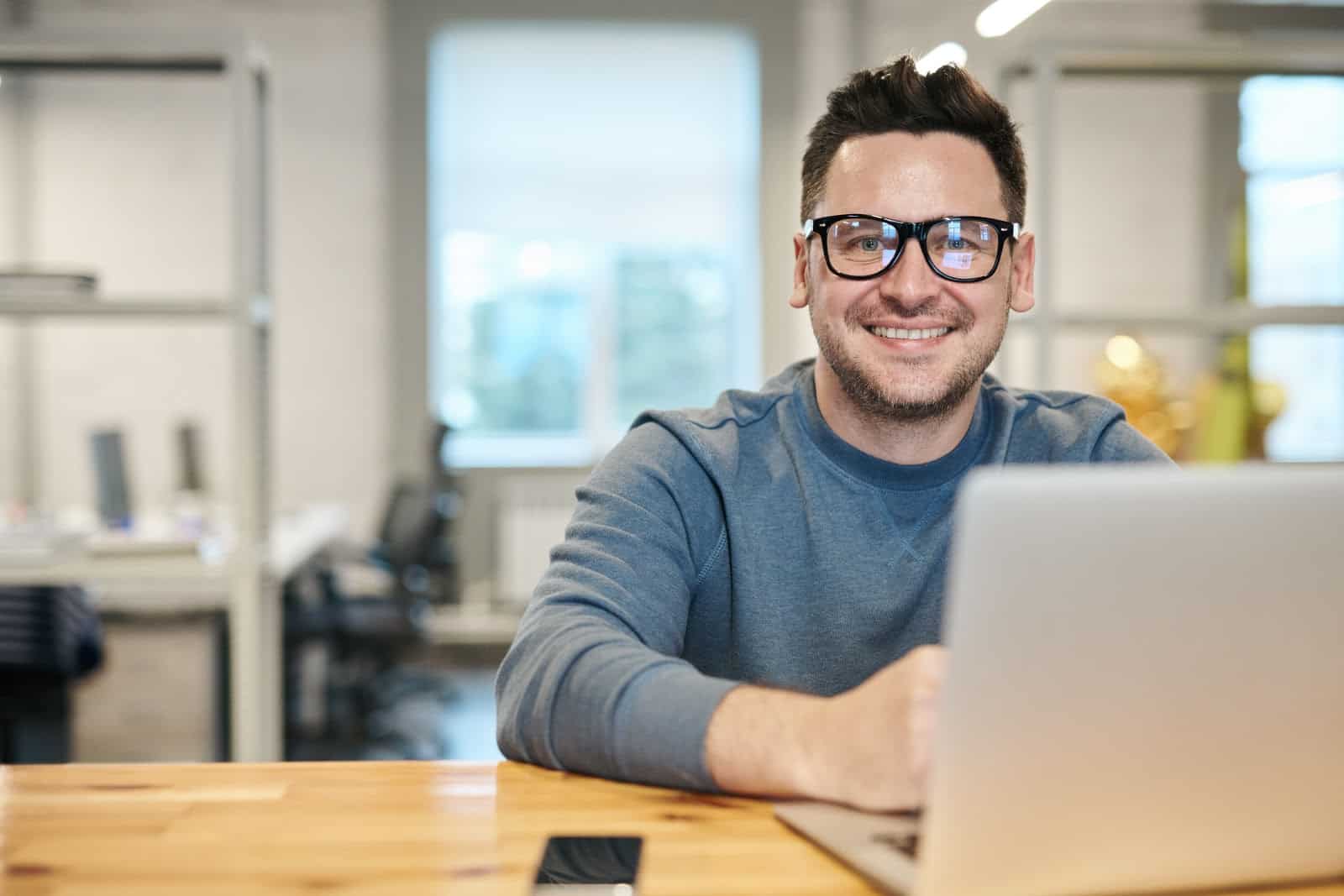 man smiling at computer