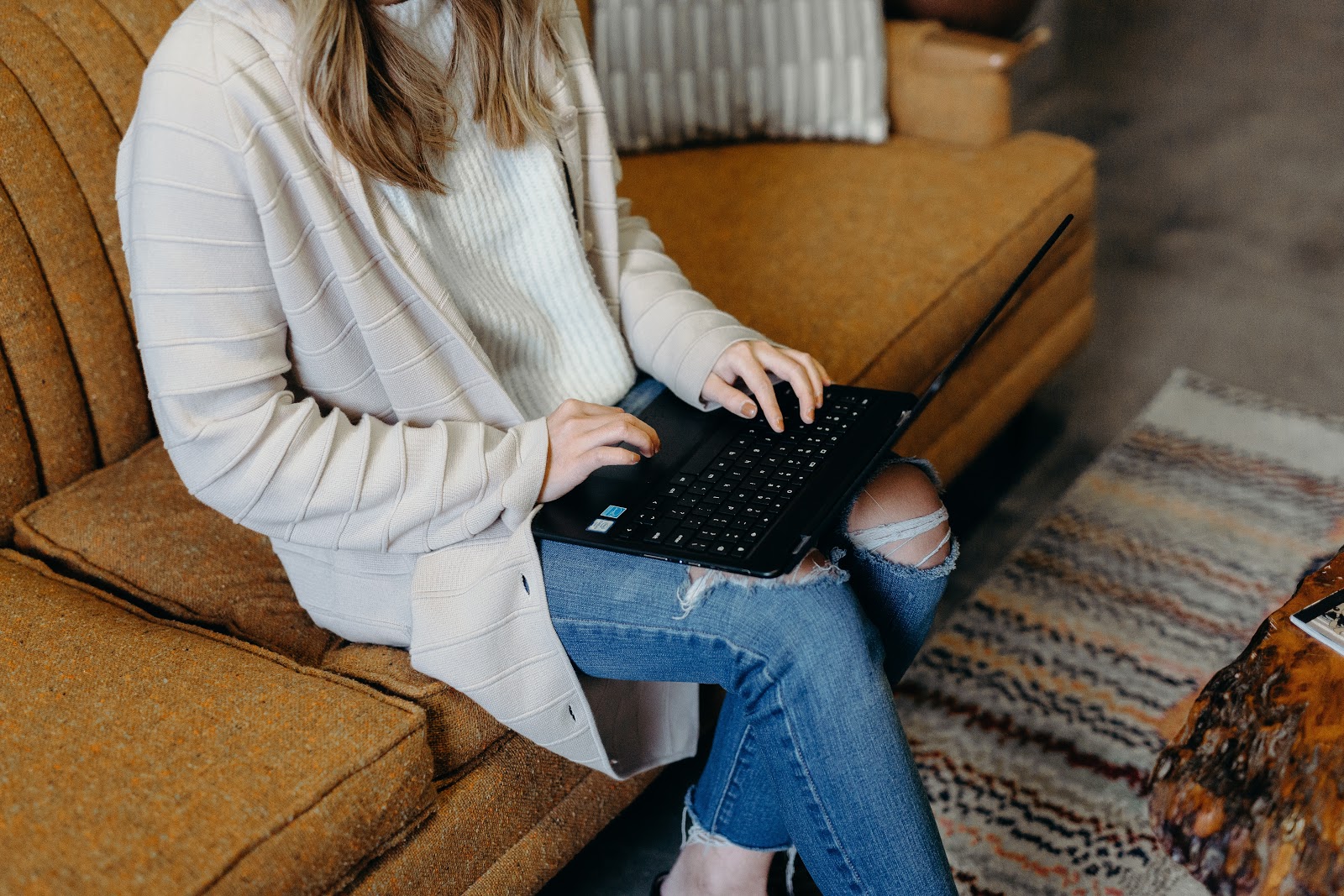 woman searching on laptop for Amazon Gift Card Deals