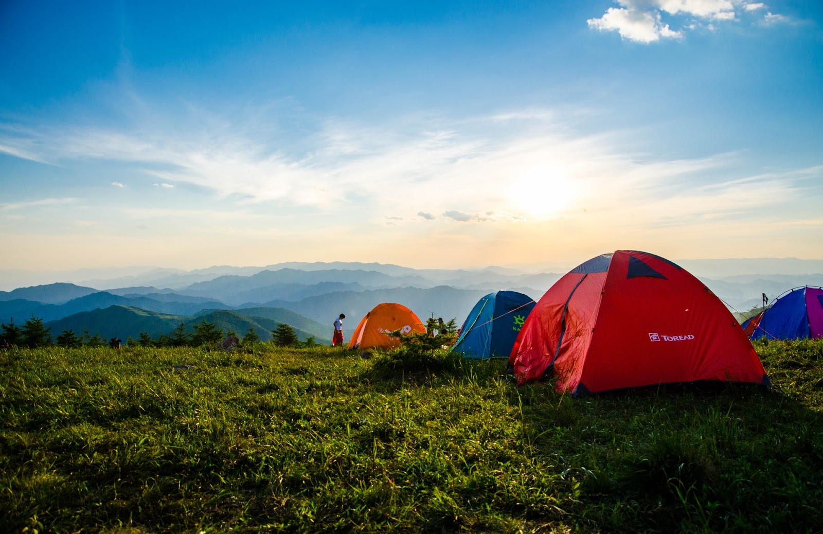 What Is a B Corporation: pitched dome tents overlooking mountain ranges
