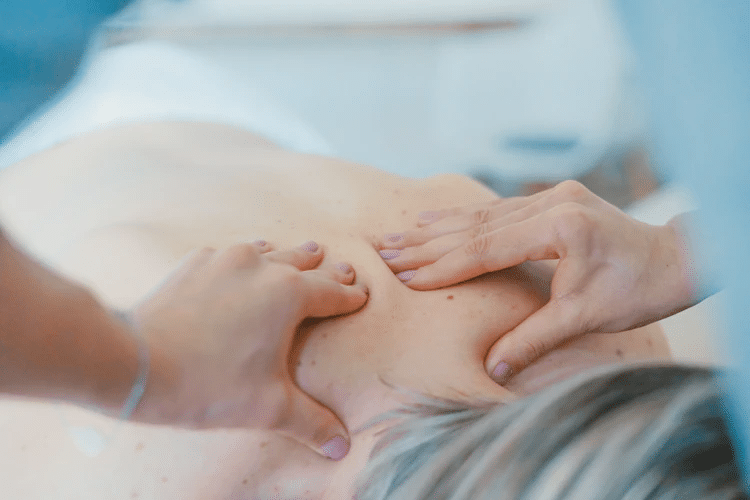 Woman receiving a massage as you might using the Soothe app