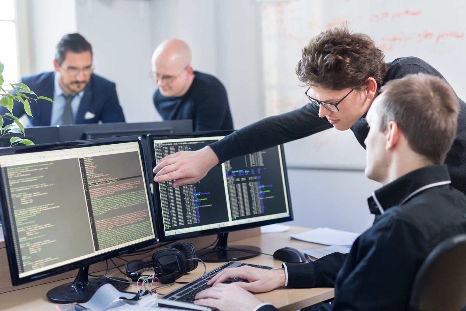 What is Jira: Programmers and Developers programming on a desktop computer