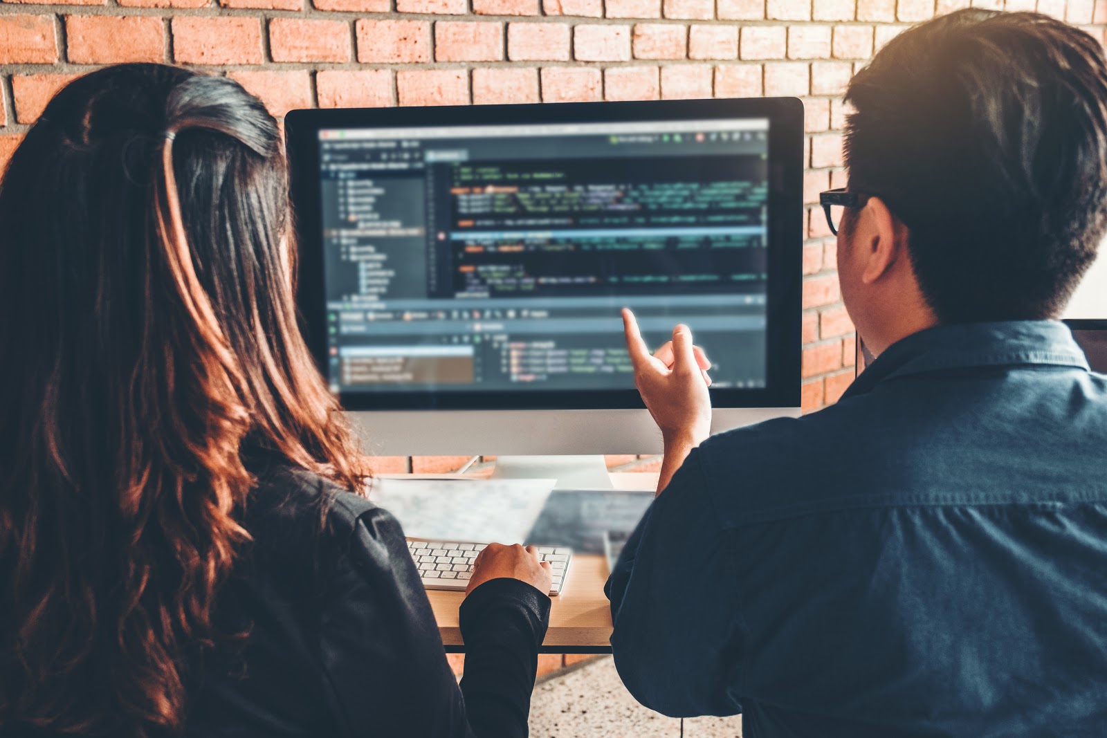 Two people looking at a computer screen