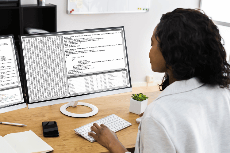 A medical coder working on a computer in the office