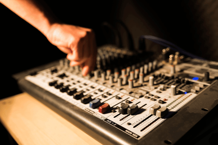 Close-up of a producer working on a professional DJ board