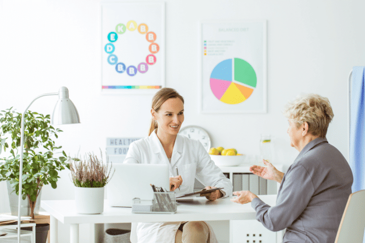 A cheerful female Dietitian doctor talking with her patient in a clinic
