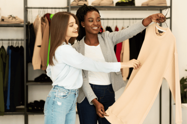 A fashion stylist choosing a fashionable dress for her client in the showroom