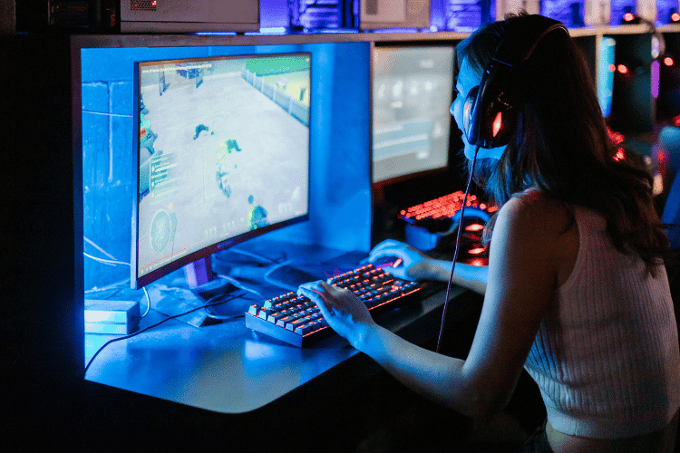 A female game tester playing on a computer