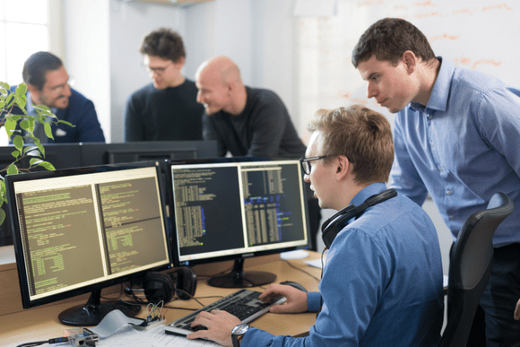 A mentor checking the work of a junior software engineer