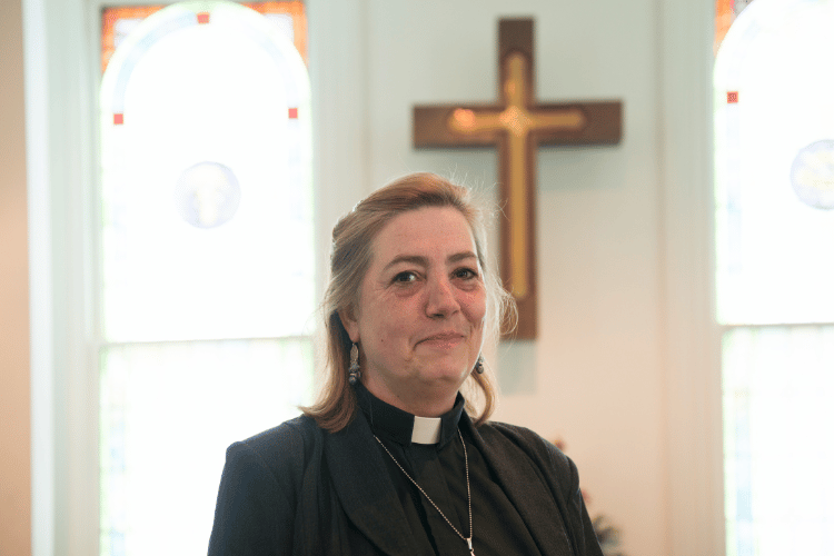 A smiling Ordained Minister in a church