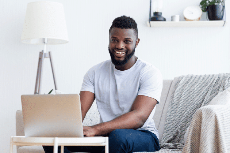 A smiling man selling Sports Cards online at his house