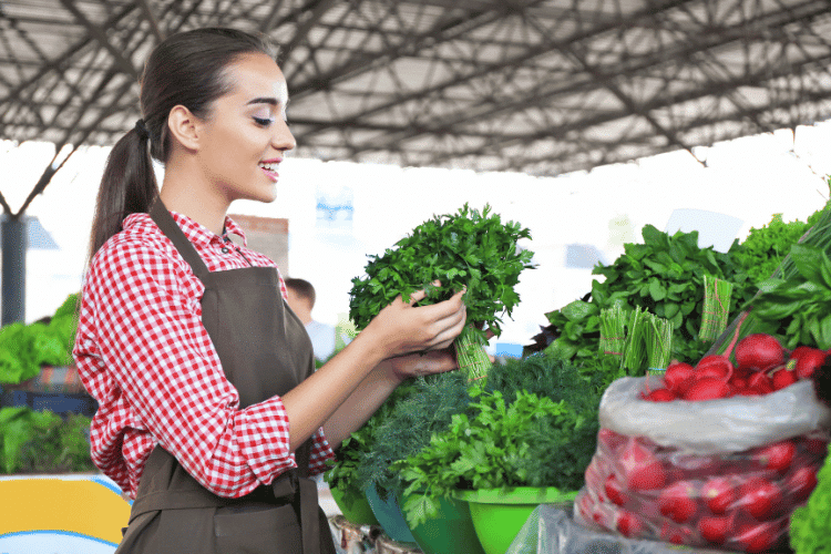 A young female seller in farmers market
