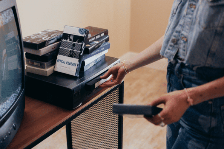 A young woman holding a VHS Tape