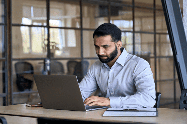 An accredited investor working on laptop in his office