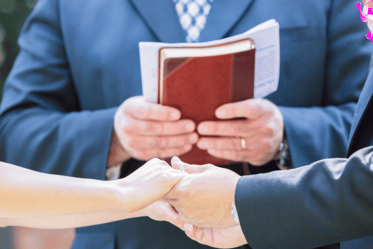 Close-up of Ordained Minister and a married couple
